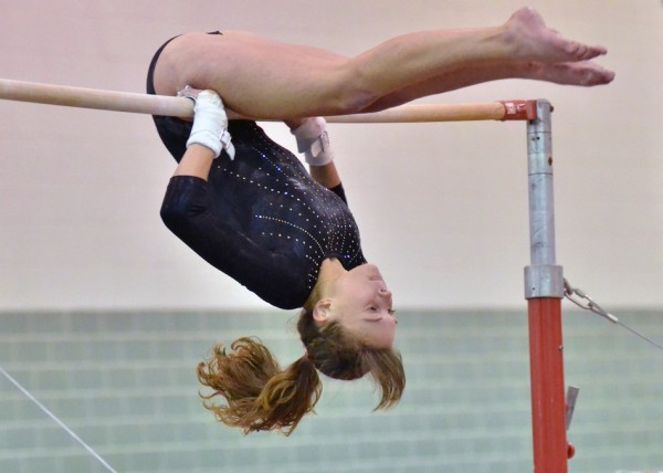 Senior Deea Coy performs on the bars for Wawasee.