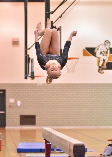 Taylor Busse grabs some air during her beam routine.