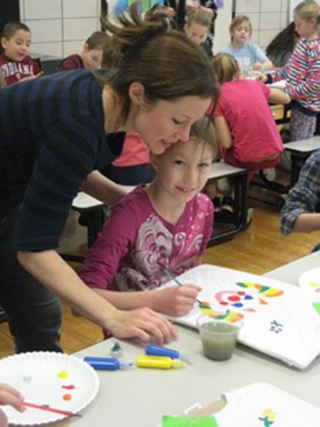 Claire Sprankle is shown with her mother working on her circus shirt.