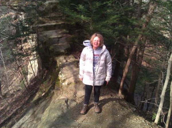 Andrea Neal stands on the trail over Devil's Backbone, 6-feet wide, with sheer drop-off on both sides.