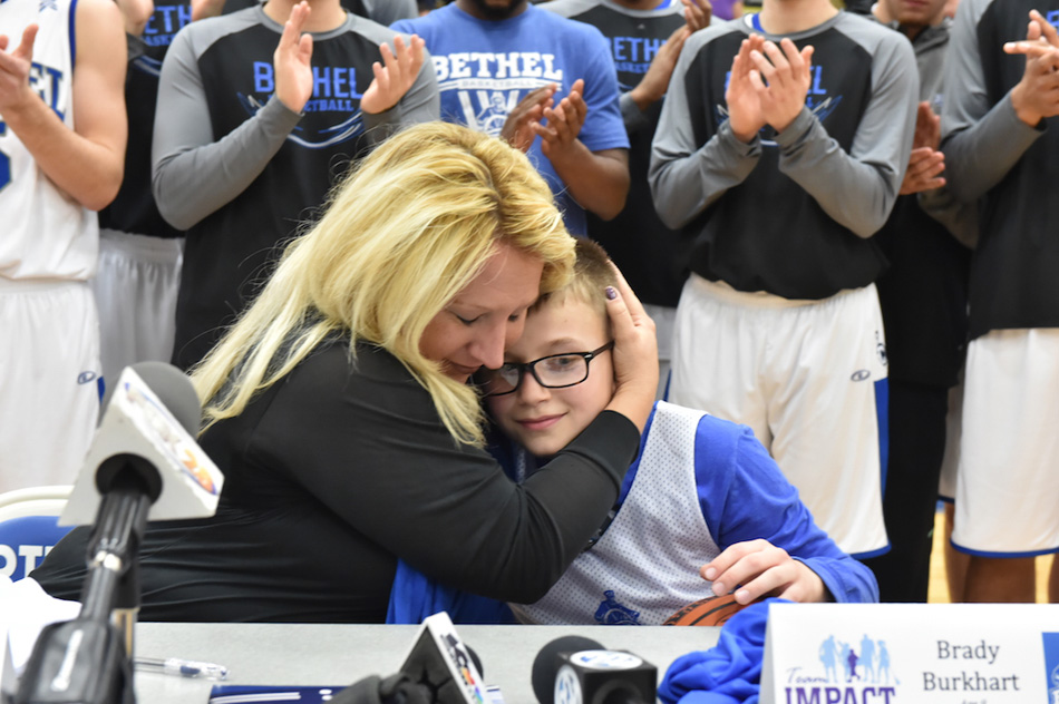 Farrah Burkhart hugs Brady during his signing day with Bethel College.