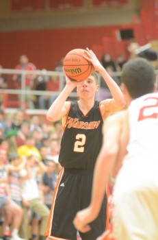 Kyle Mangas readies to let fly with a jumper. The sophomore led the Tigers with 13 points.