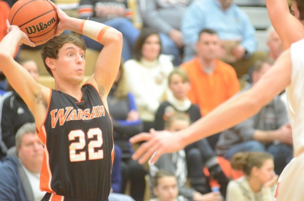 Tim Swanson looks to pass the ball versus Plymouth Thursday night. Swanson hit two free throws in the closing seconds to seal a 42-38 Warsaw win.