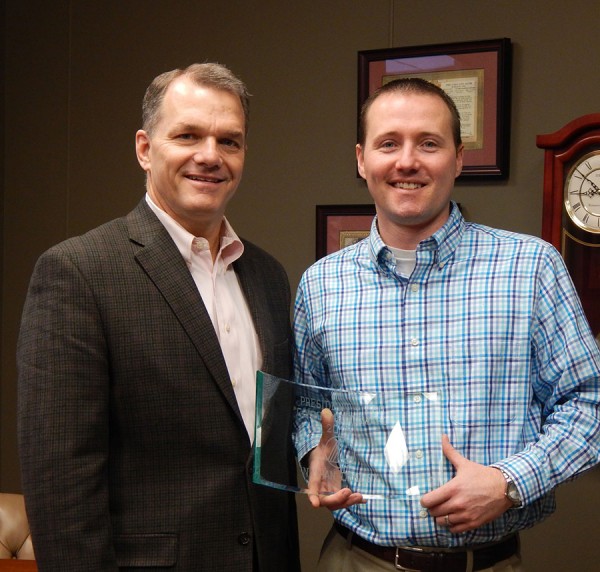 David M. Findlay (L), Lake City Bank President and CEO presents Nathan R. Conley (R), Assistant Vice President and Small Business Officer with the 2015 President and CEO Commitment Award.