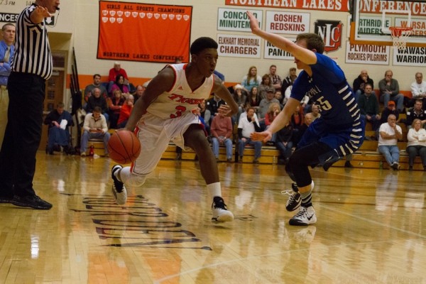 Warsaw guard Paul Marandet played a brilliant floor game with eight assists Friday night. The Tigers edged Carroll 48-47 in overtime in the regular-season finale (Photo by Ansel Hygema)