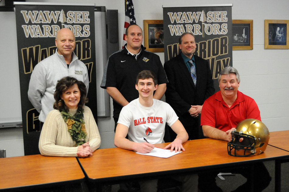Wawasee High School senior Clayton Cook signed his letter of intent to continue his football career at Ball State University. Seated with Clayton are parents Peggy and Frank Cook. In back are WHS athletic director Steve Wiktorowski, WHS head football coach Josh Ekovich and WHS principal Mike Schmidt. (Photo by Mike Deak)