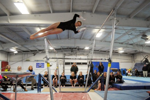 Wawasee's Taylor Busse launches between the uneven bars at Elkhart Central Thursday evening. (Photos by Mike Deak)