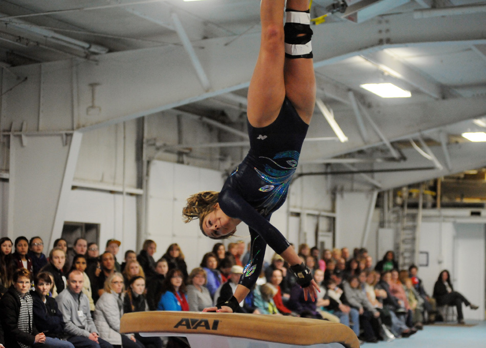 Elkhart Central senior Libby Yeakey elevates off the vault during her final home performance Thursday night against Wawasee.