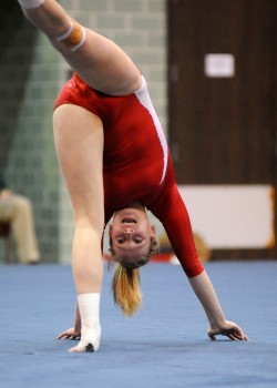 Cassi Quissell of Plymouth was heels over head Tuesday, flipping to a 9.525 on floor.