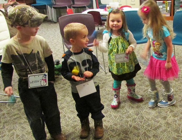 Westen Haab, Owen Morehouse, Lylah Young, and Jocelyn Keller shake their maracas to some music on Wednesday, March 11 at Preschool Winter Story Time. After dancing and listening to stories, they made their very own noise makers to take home.