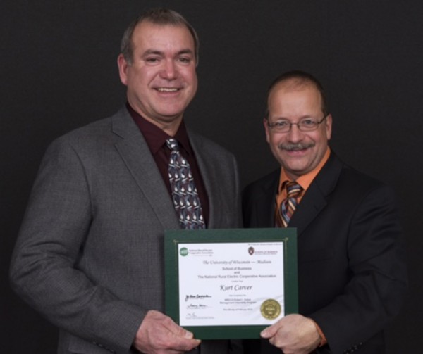 Kurt Carver, Kosciusko REMC, left, recently graduated from the University of Wisconsin’s Robert I. Kabat Management Internship Program for the electric utility industry. Pictured with Carver to celebrate his achievement is Gary Pfann, National Rural Electric Cooperative Association, on the right. (Photo provided)