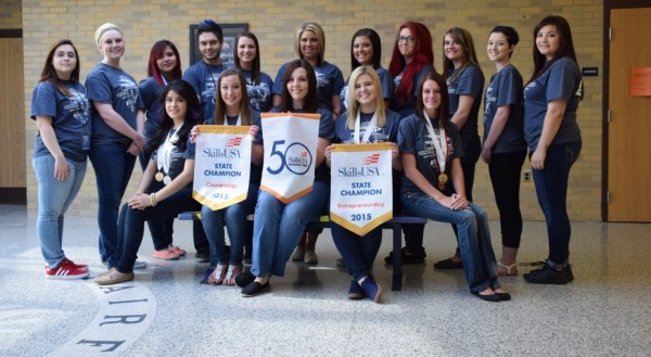 Fairfield cosmetology students proudly display their champion banners from SkillsUSA. In front, from left, are Esmeralda Rocha, Michaela Jones, Halie Tinkey, Olivia Huffman and Chelsea Kidd. In the back row are Maria Magallanes, Carley Moore, Leslie Hernandez, Jacob Weber, Abigail Stuckman, Alyssa Stuckman, Keyanna Hann, McKenzie Schmitt, Cynthia Wagner, Trisha Varney and Melissa Hernandez. Not pictured is Brianna Pena.