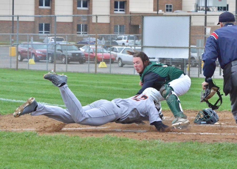 Wawasee's Nate Prescottt applies the tag at home to Warsaw's Sterling Kay in the first inning of the Warriors 8-2 win over the Tigers. (Photos by Nick Goralczyk)