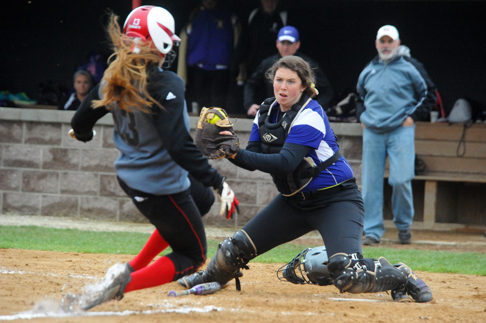 Taylor University catcher Davis Carter is set to lay a tag on Grace College's Hannah Herbster during game one of the doubleheader Tuesday.