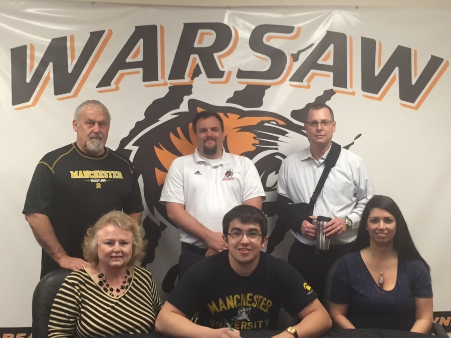 WCHS senior Rory Nolin will wrestle at Manchester University. Nolin is shown above in front, flanked by Jane Nolin (at left) and Jessica Peters. In back (from left) are Jerry Nolin, Warsaw wrestling coach Justin Smith and Andy Peters (Photo provided)