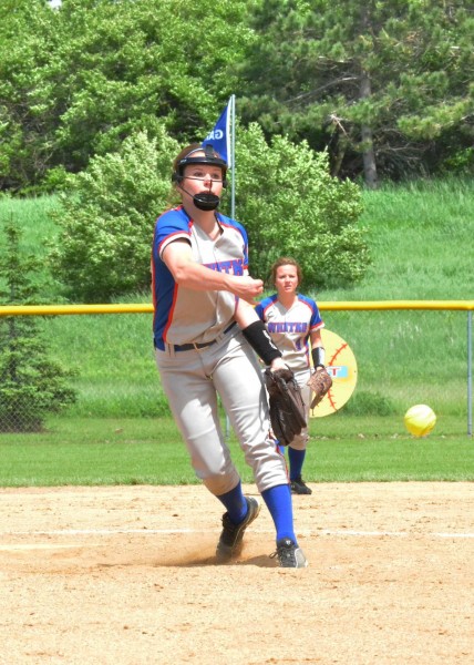 Hanna Yohe (front) rifles a pitch for the Wildcats while Haley Yohe stands ready at second base.