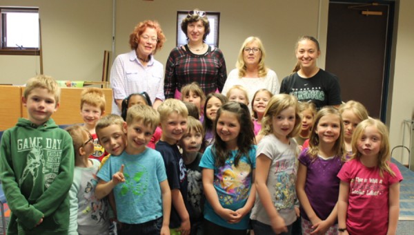 Children in kindergarten and first grade are visiting the library during the month of may.  Shown is one class after reading a story, before they sit down for tea and to look at the many books available. The library offers eight weeks of exciting summer reading programs that begin on June 9. 