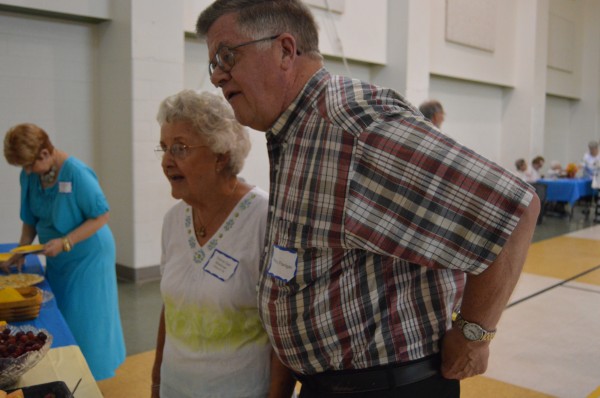 Donna (Darr) Workman and Patrick Flanigan share a moment with other attendees at the annual Syracuse High School alumni banquet.