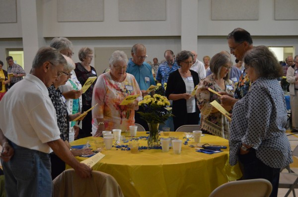 Attendees of the 106th annual Syracuse High School alumni banquet sing the school song.