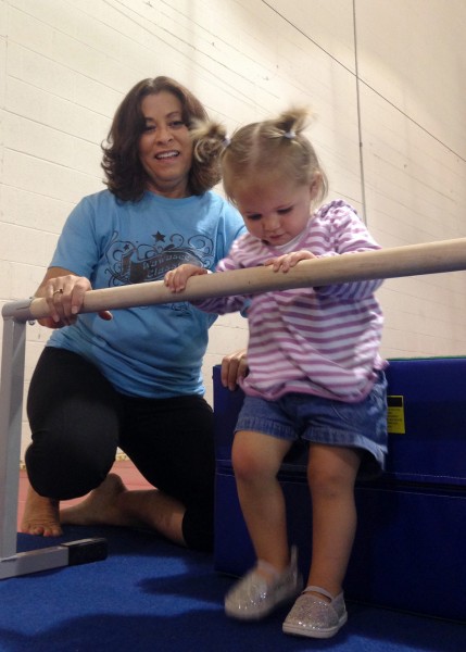 Nika Prather helps Caraline Deak through the romp and roll course at the North Webster Community Center. Romp and roll camp will be held next Monday through Wednesday. (Photo provided)