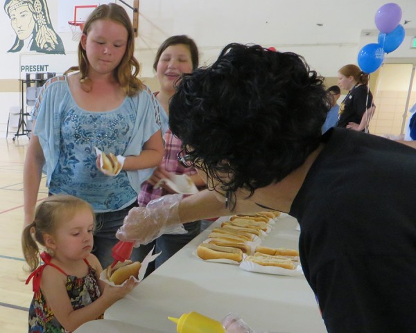 Sandy Jagger serves Sadie Small a hotdog while Anita Denney and Bella Umazor wait their turn at the North Webster Library’s Grand Finale Picnic.  The picnic culminated the Summer Reading Program in which 392 youth completed 5,305 hours of reading.