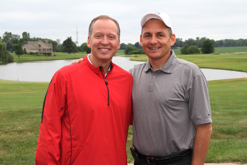 Grace College athletic director Chad Briscoe, left, poses with former Crossroads League commissioner JD Collins at the 2014 Lancer Golf Classic. (File photo provided)