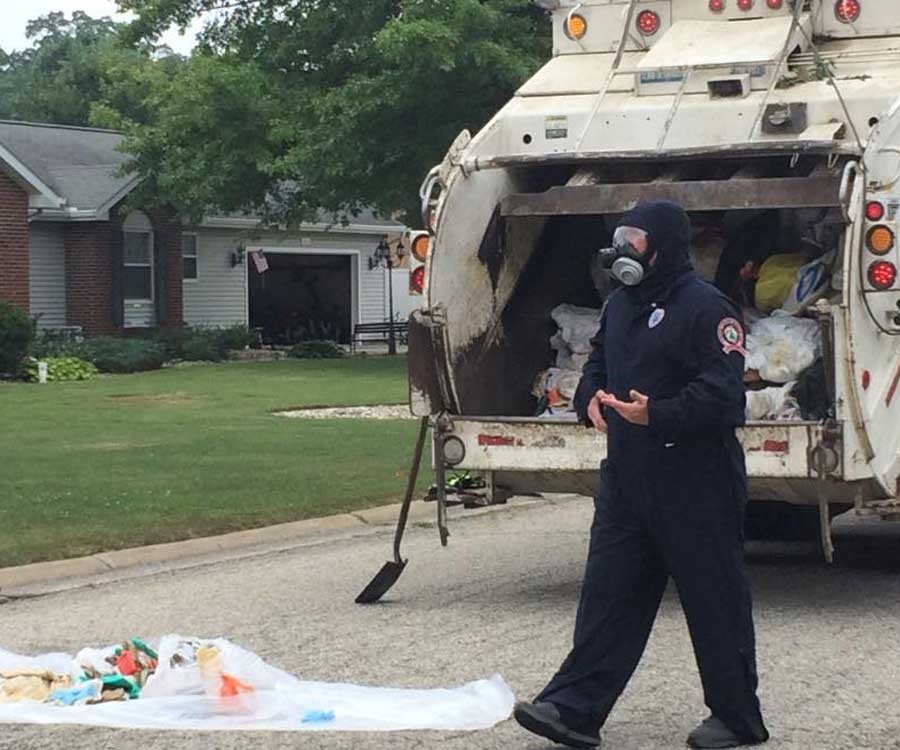 A police officer overlooking a trash heap