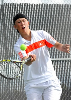 Warsaw's Colton Lind lunges for a shot attempt in No. 2 singles play.