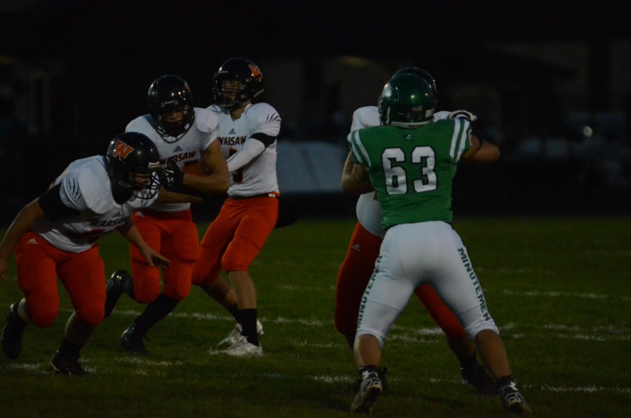 Will McGarvey takes a handoff as a pair of Warsaw linemen open a hole Friday night at Concord.