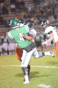 Concord quarterback Jason Grooms is crushed by a Warsaw defender.