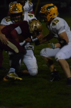 A pair of Valley defenders stop a Jimtown tailback Friday night.