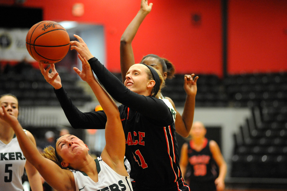 Grace's Hannah Adams scrambles for a rebound with Roosevelt's Paige Gallimore Saturday in the championship game of the Terry Polston Hoops For Hope Tournament. (Photos by Mike Deak)