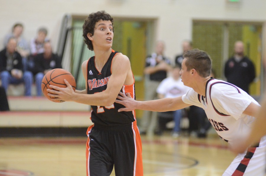 Ross Johnson looks for a teammate to pass to for the Tigers.