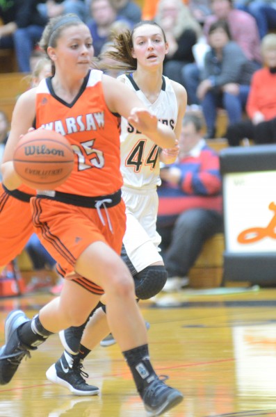 Madi Graham races upcourt for Warsaw. Graham led her team with 14 points Saturday.