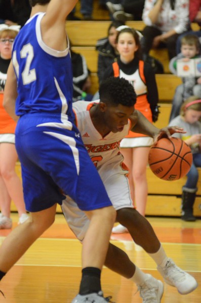 Warsaw guard Paul Marandet drives the baseline versus Marian Tuesday night. The Tigers remained undefeated with a 47-38 overtime win.