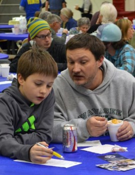 Rhyse and Chad Jonsson circle their favorite soups, as they taste them together during the annual Kiwanis Soup Supper.