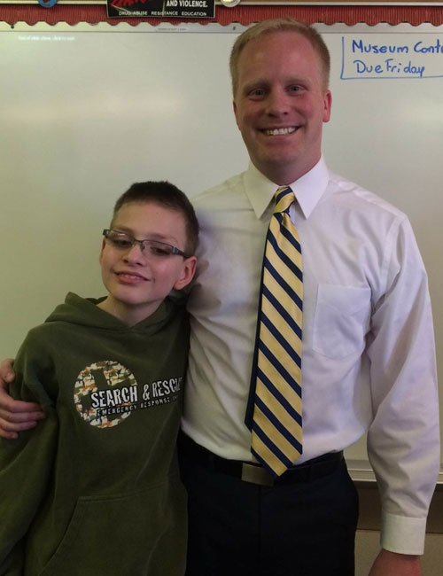 Rudkin poses with a Lincoln Elementary student.