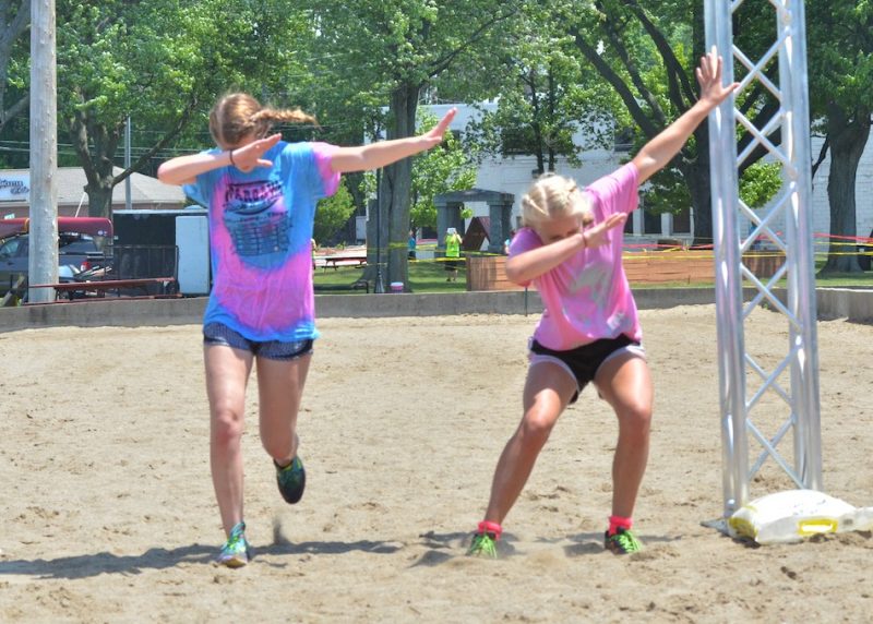 Ashley Bishop and Megan Metzger dab as they cross the finish line.