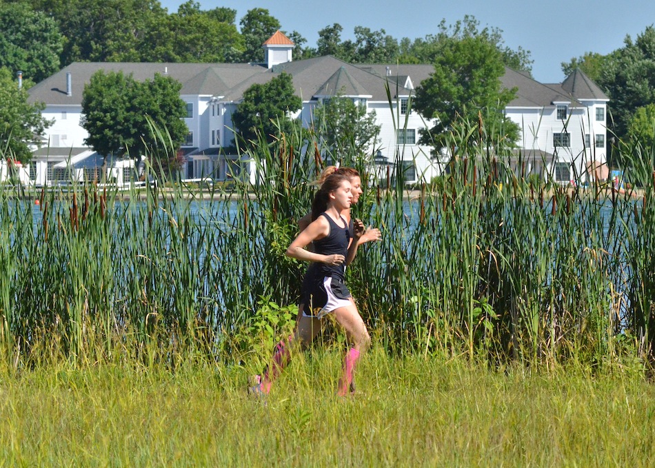 Linda and Isabelle Moore jog side-by-side near the shore of Lake Wawasee during Saturday's Mudtastic Classic. (Photos by Nick Goralczyk)