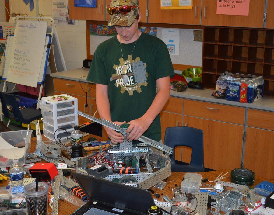 Ethan Hays, Wawasee High School student, works with a robot during a summer camp for robotics.