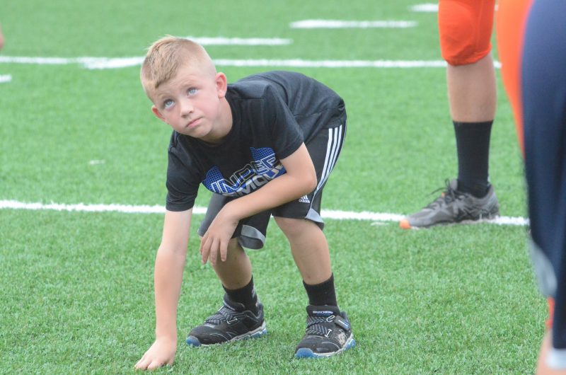 A camper listens for instructions from a Warsaw player Friday night. The Tigers held a camp prior to their scrimmage with Tippecanoe Valley.