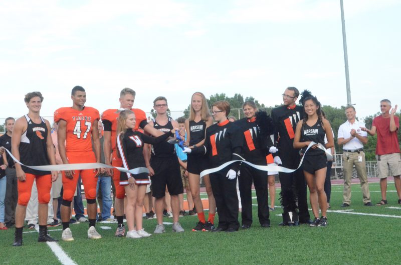 Members of the WCHS student body cut the ribbon for the new synthetic turf field Friday night.