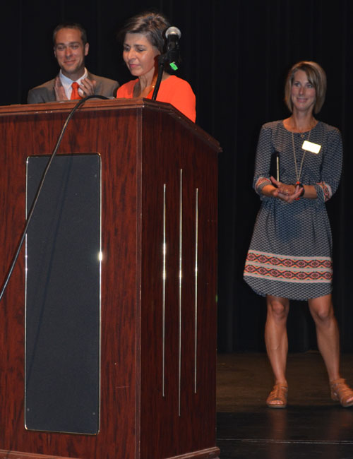 In back from left, Superintendent Dr. David Hoffert and School Board Member Heather Reichenbach bid farewell to outgoing school board member Jennifer Tandy, pictured in front.