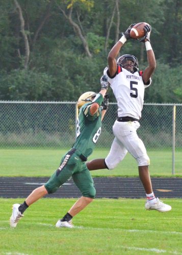 DeAndre Smart makes an athletic grab over a Wawasee defender during Friday's win over the Warriors. (Photos by Nick Goralczyk)