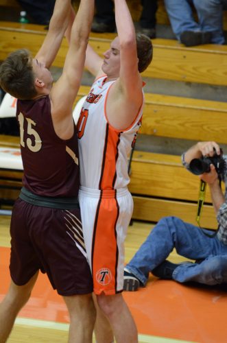 Warsaw's Braxton Minix is defended by Parker Hazen. Minix had seven points and seven rebounds.