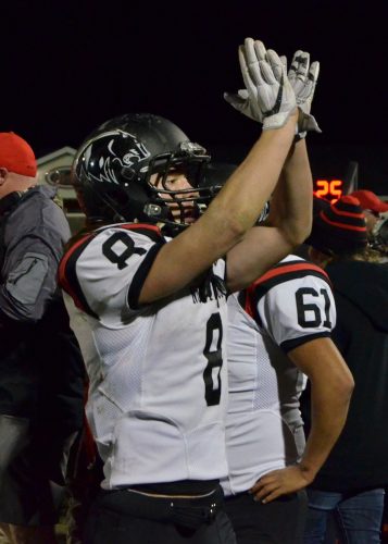 Landen Gessinger signals to the Panther faithful following Friday's win over Lowell. (File photos by Nick Goralczyk)